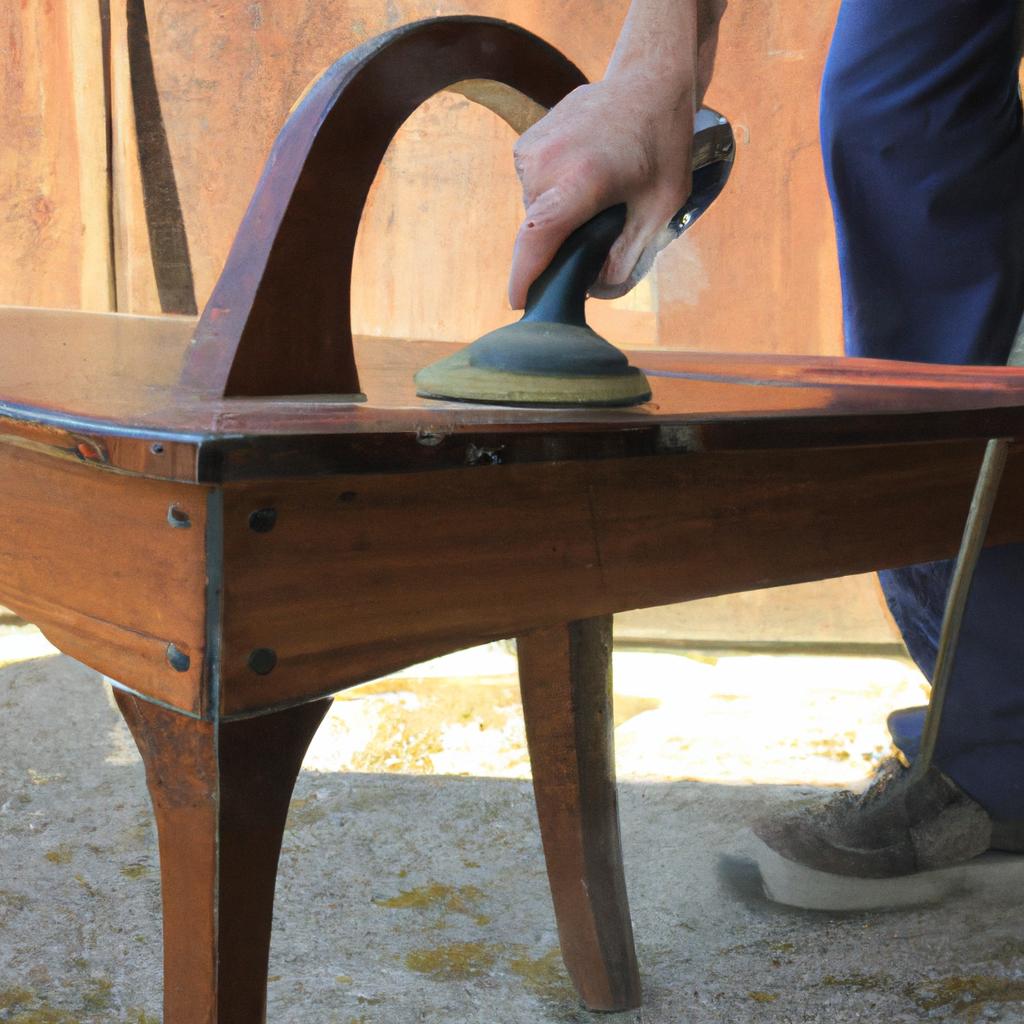 Person sanding old wooden furniture