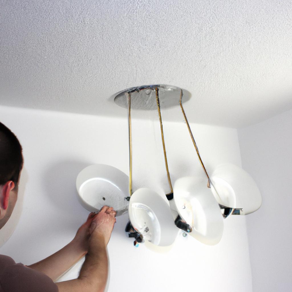 Person installing lighting fixtures at home