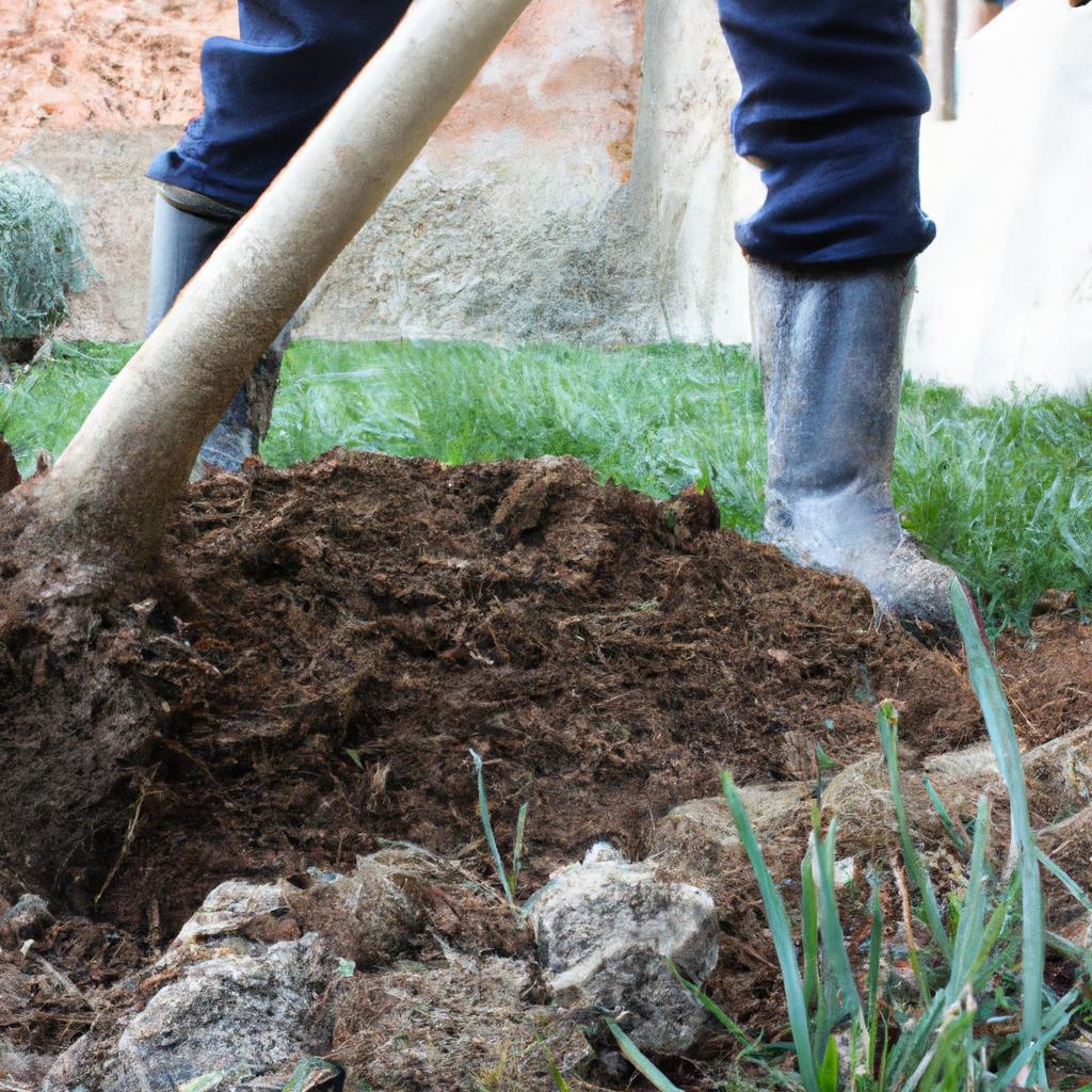 Person digging soil in garden